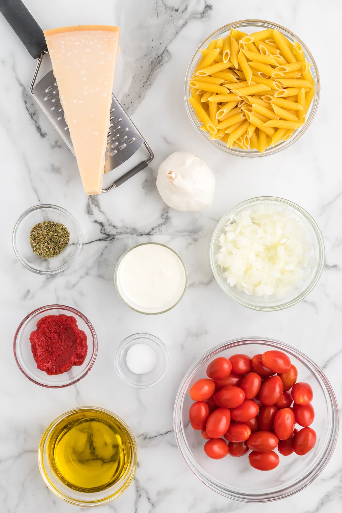 ingredients for the creamy pomodoro sauce in small glass bowls. 