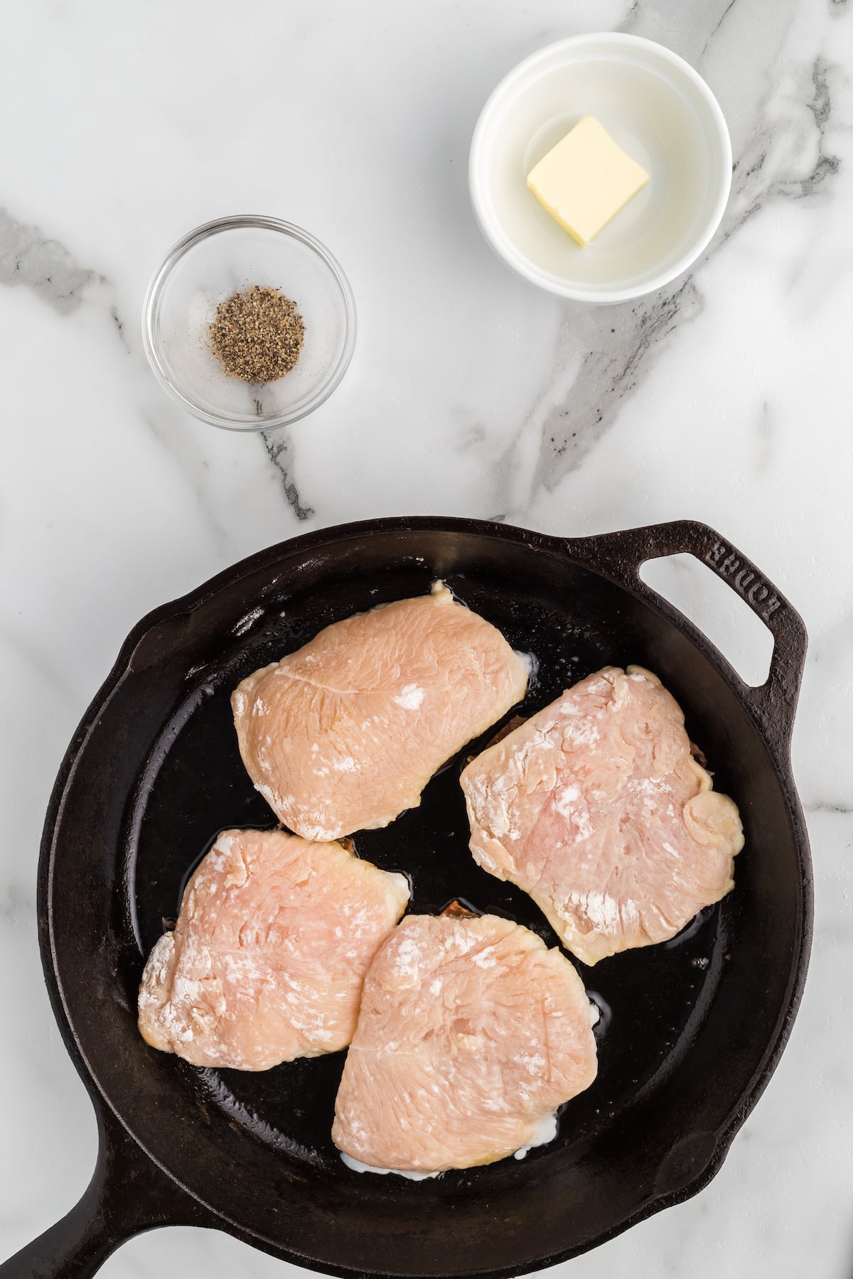 chicken saltimbocca added to a cast iron skillet. 
