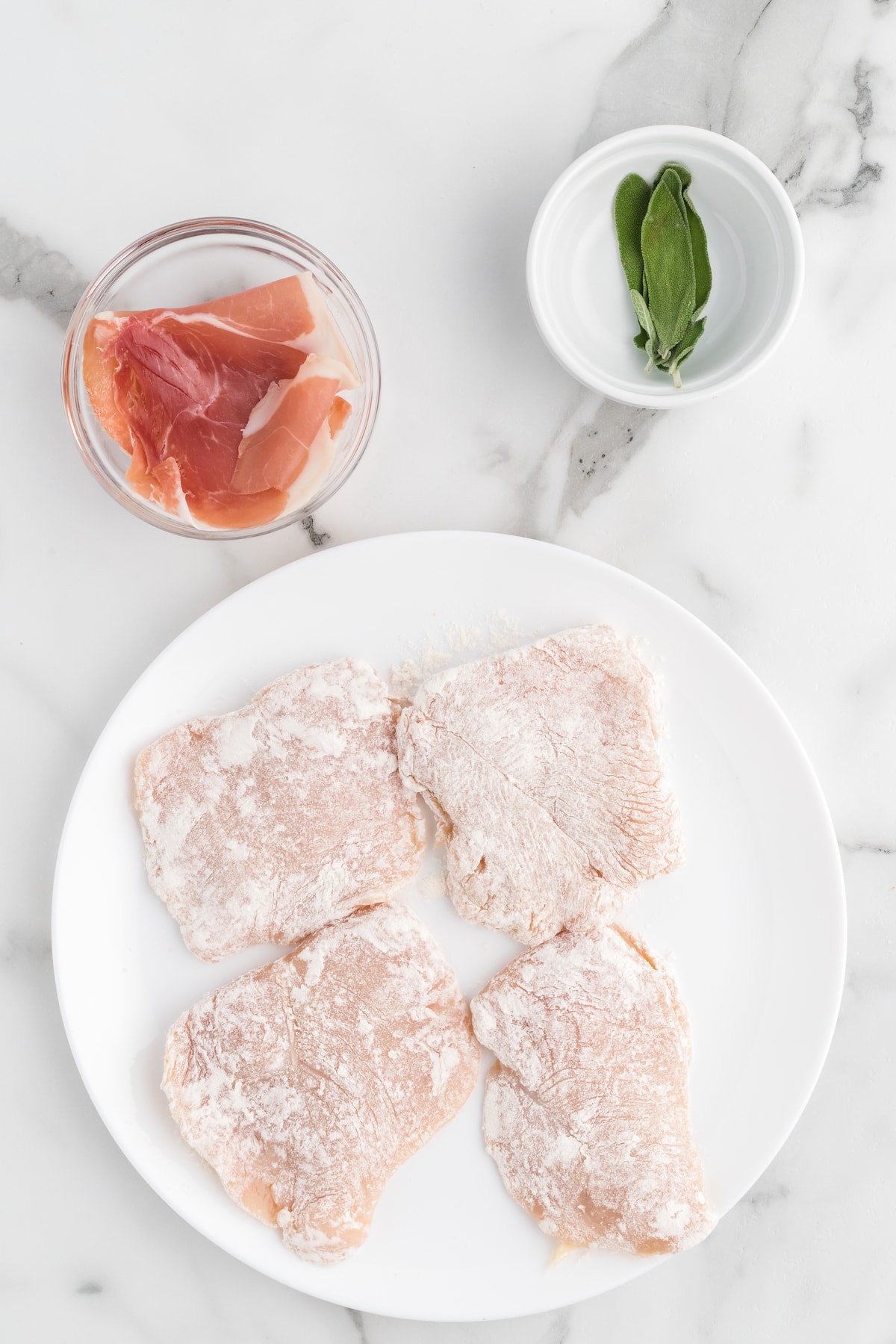 chicken cutlets covered in flour.