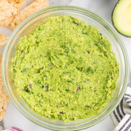 glass bowl of homemade guacamole without tomatoes