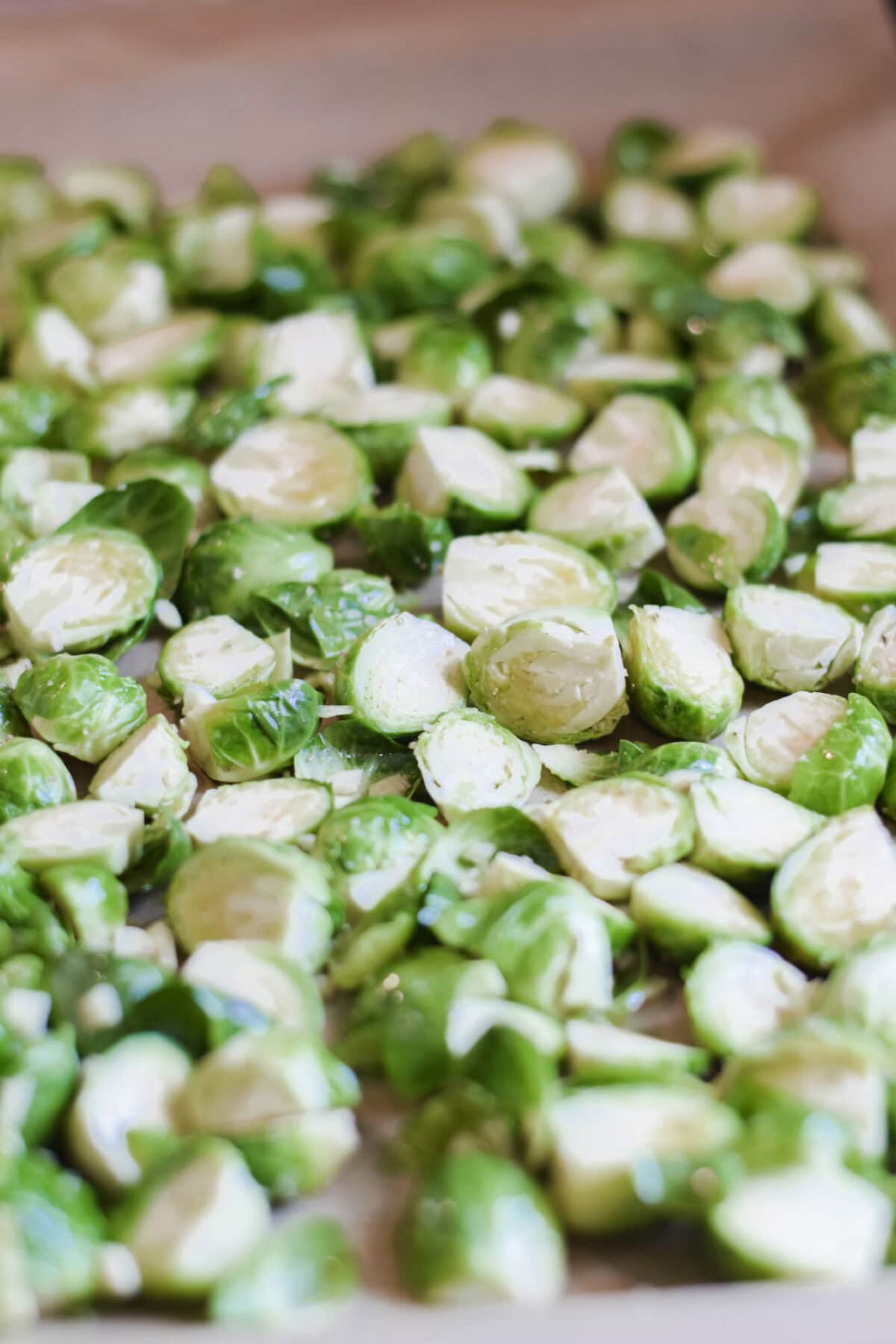 cleaned and sliced Brussels sprouts on a baking sheet.