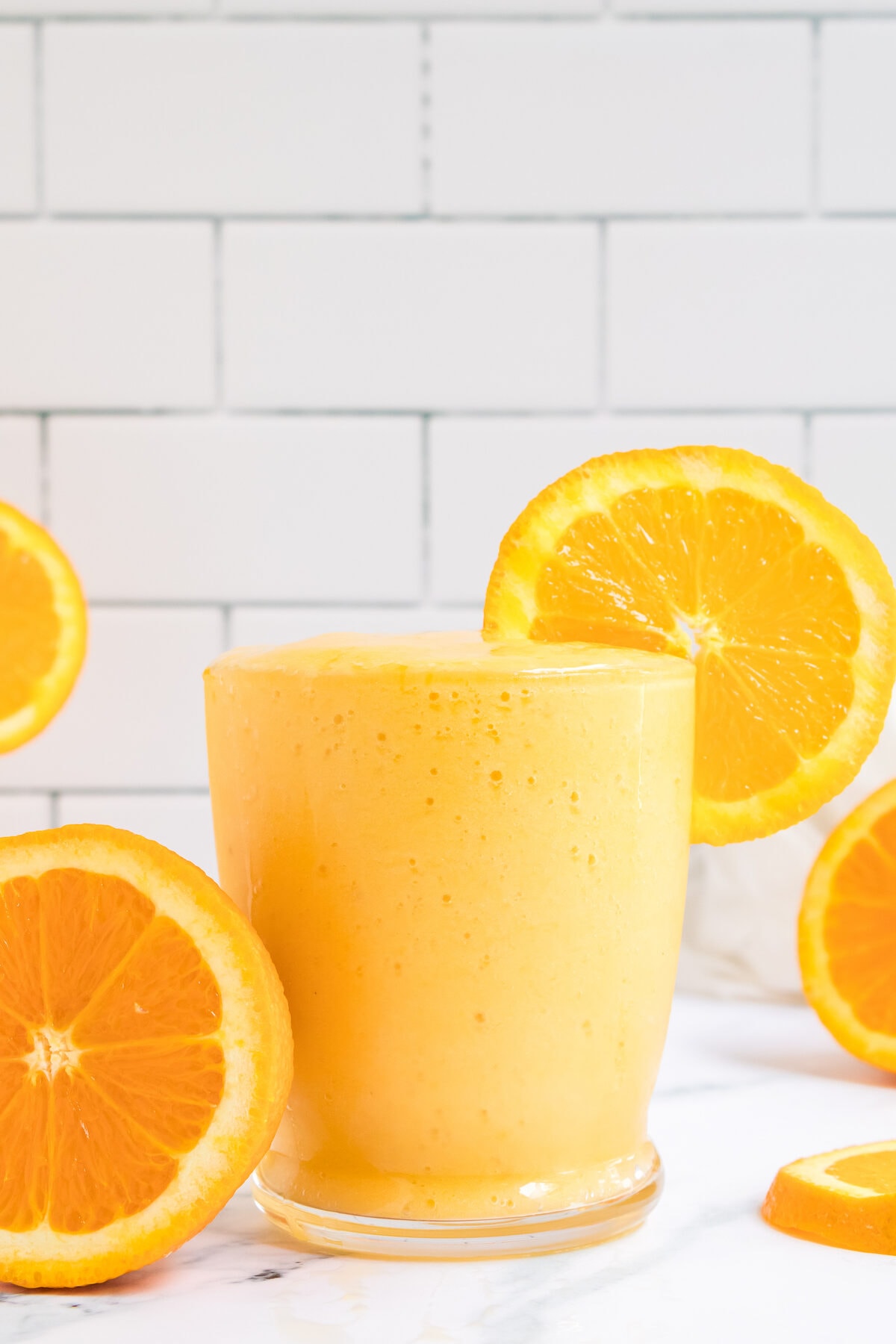 glass of orange mango smoothie.