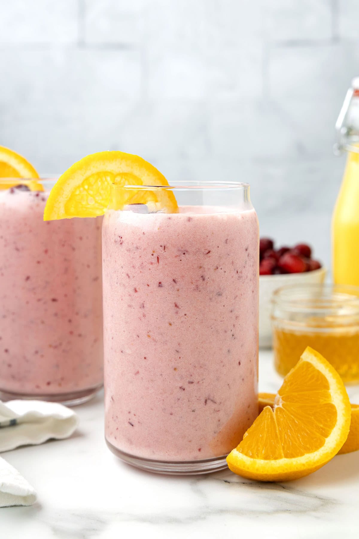 two glasses of cranberry orange smoothie. 