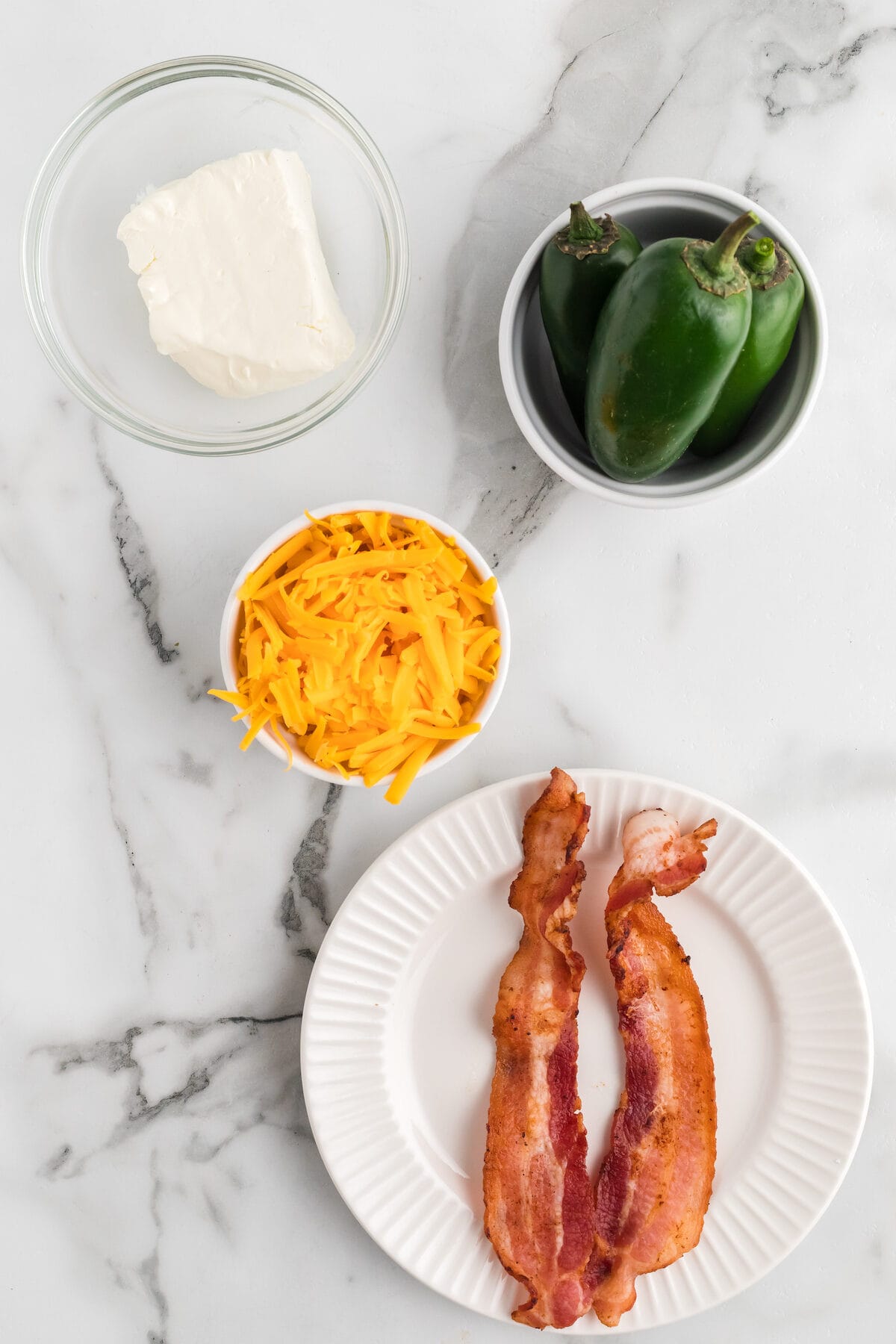 ingredients for the jalapeno poppers in small glass bowls