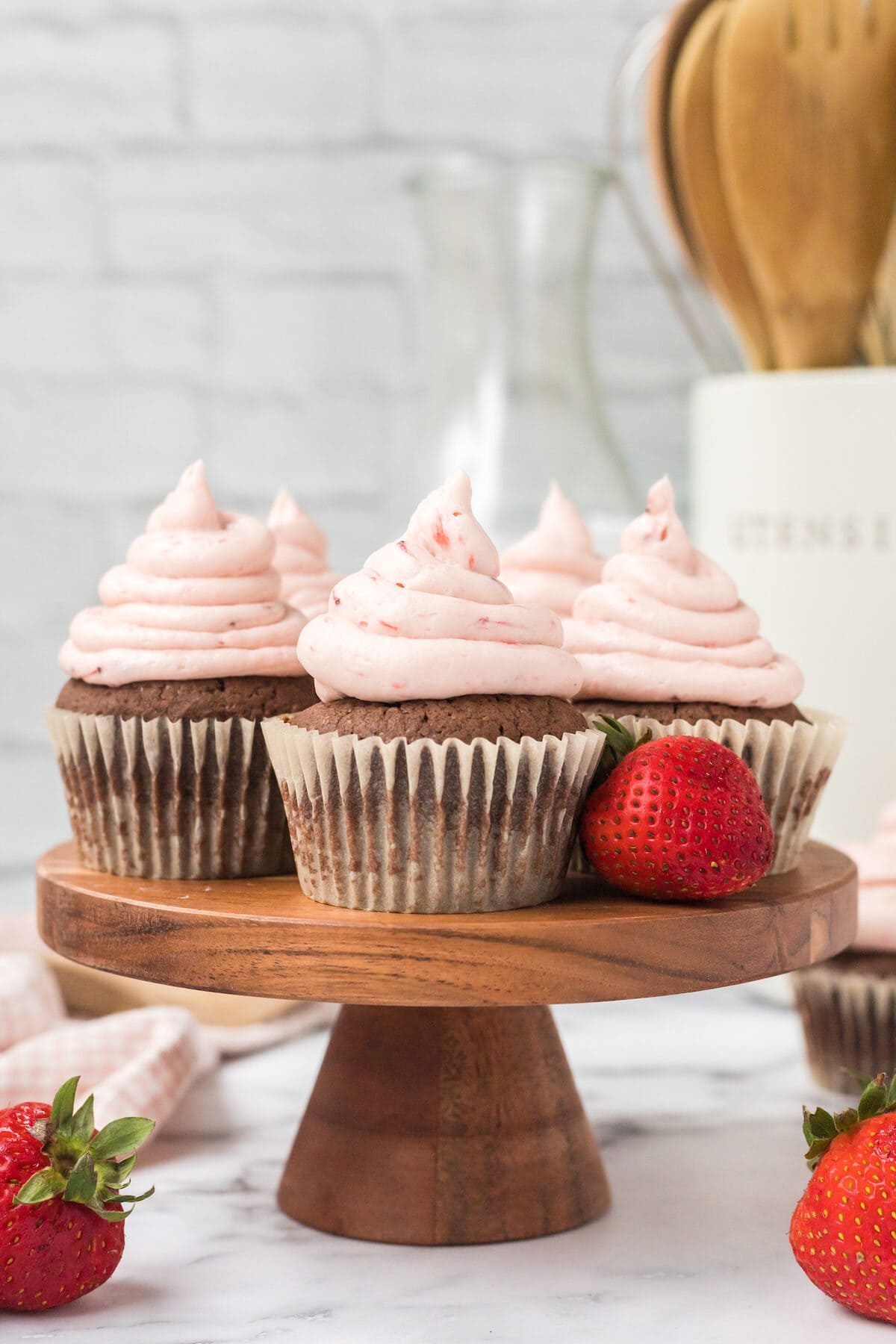 strawberry nutella cupcakes on a cake stand. 