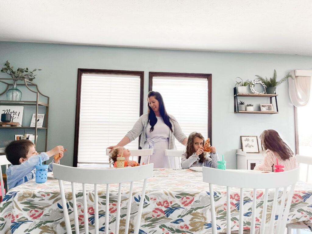 Mary with children gathered at the family dining table. 