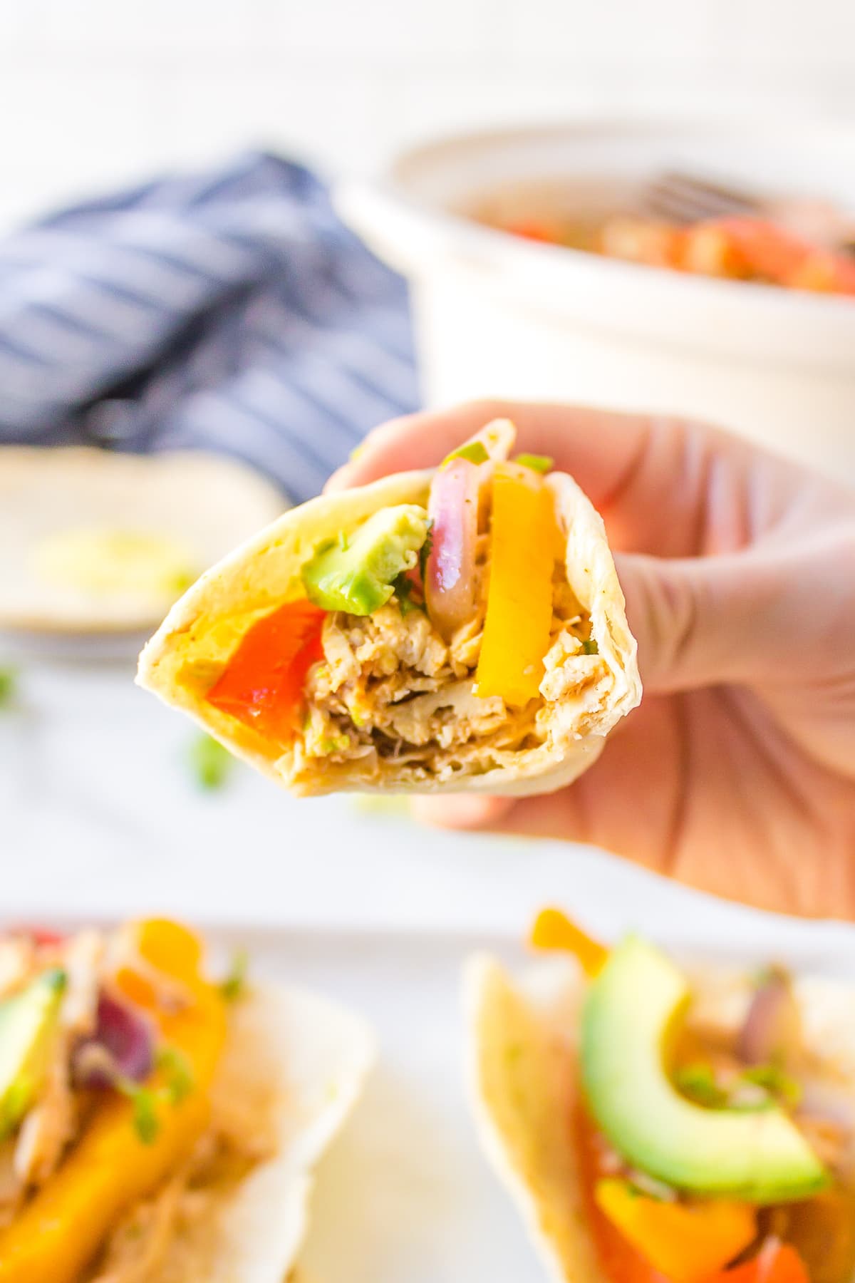 bite taken out of individual slow cooker chicken fajitas.