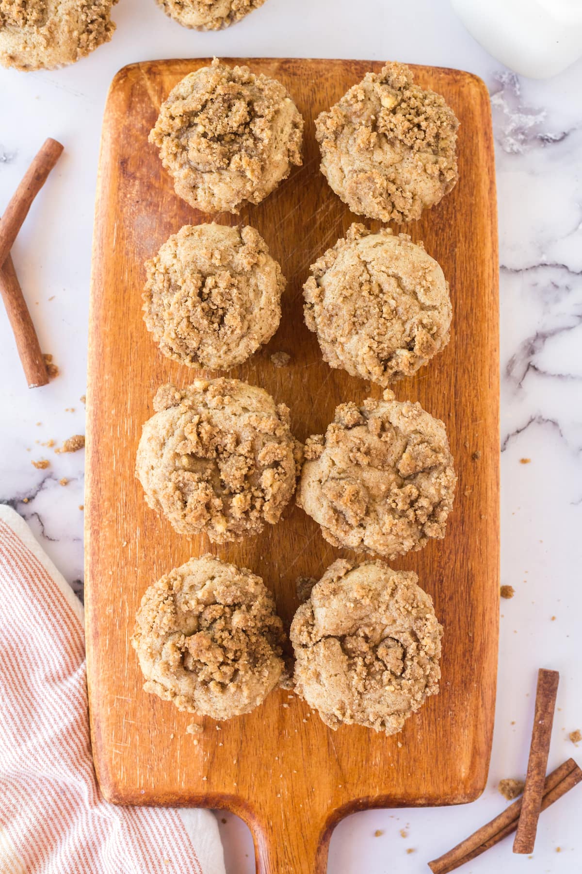 wooden board with cinnamon crunch muffins. 
