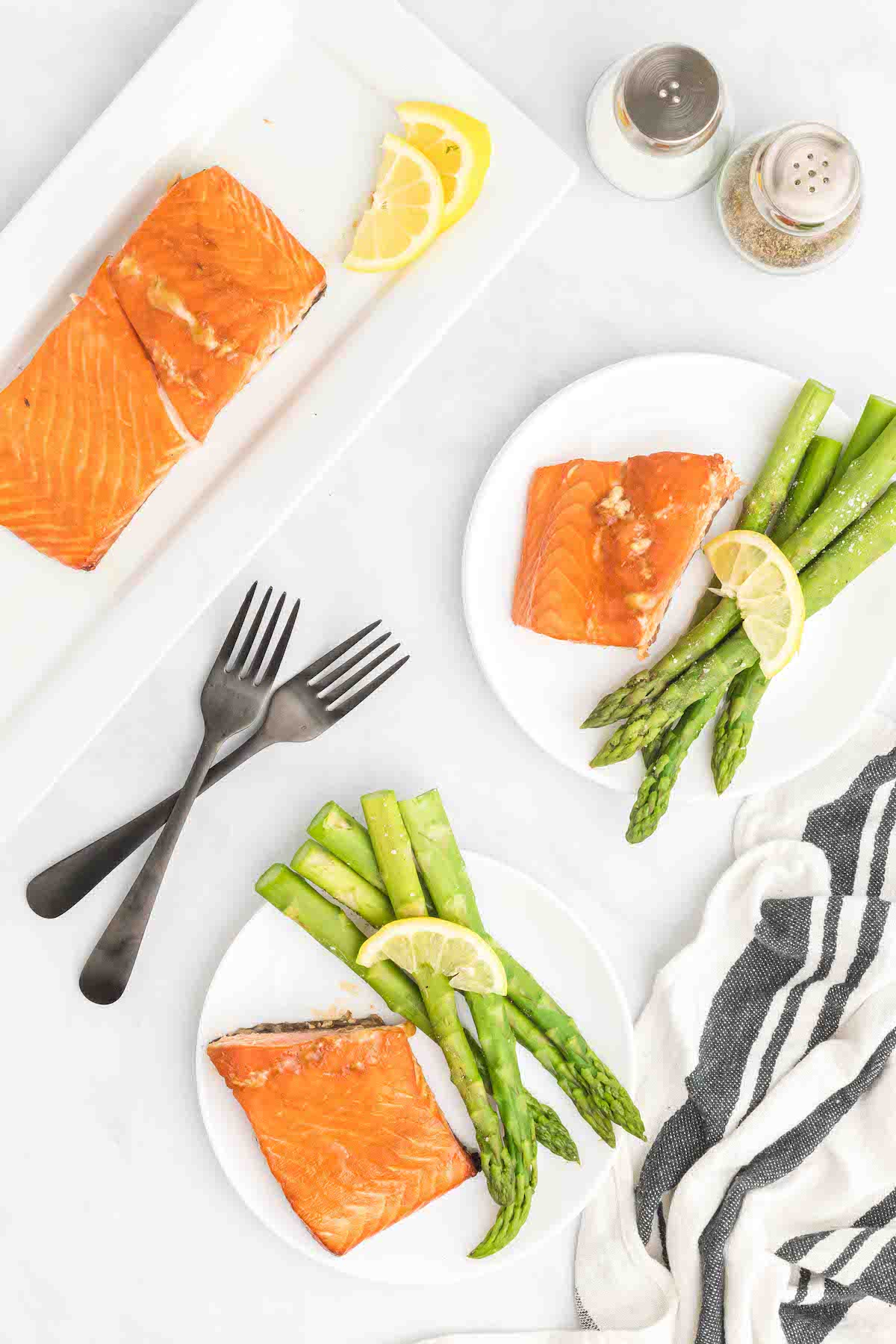 white plates with smoked salmon and asparagus.