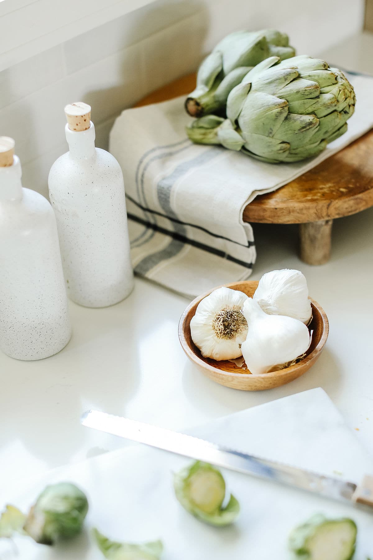 artichokes and garlic on the counter top. 