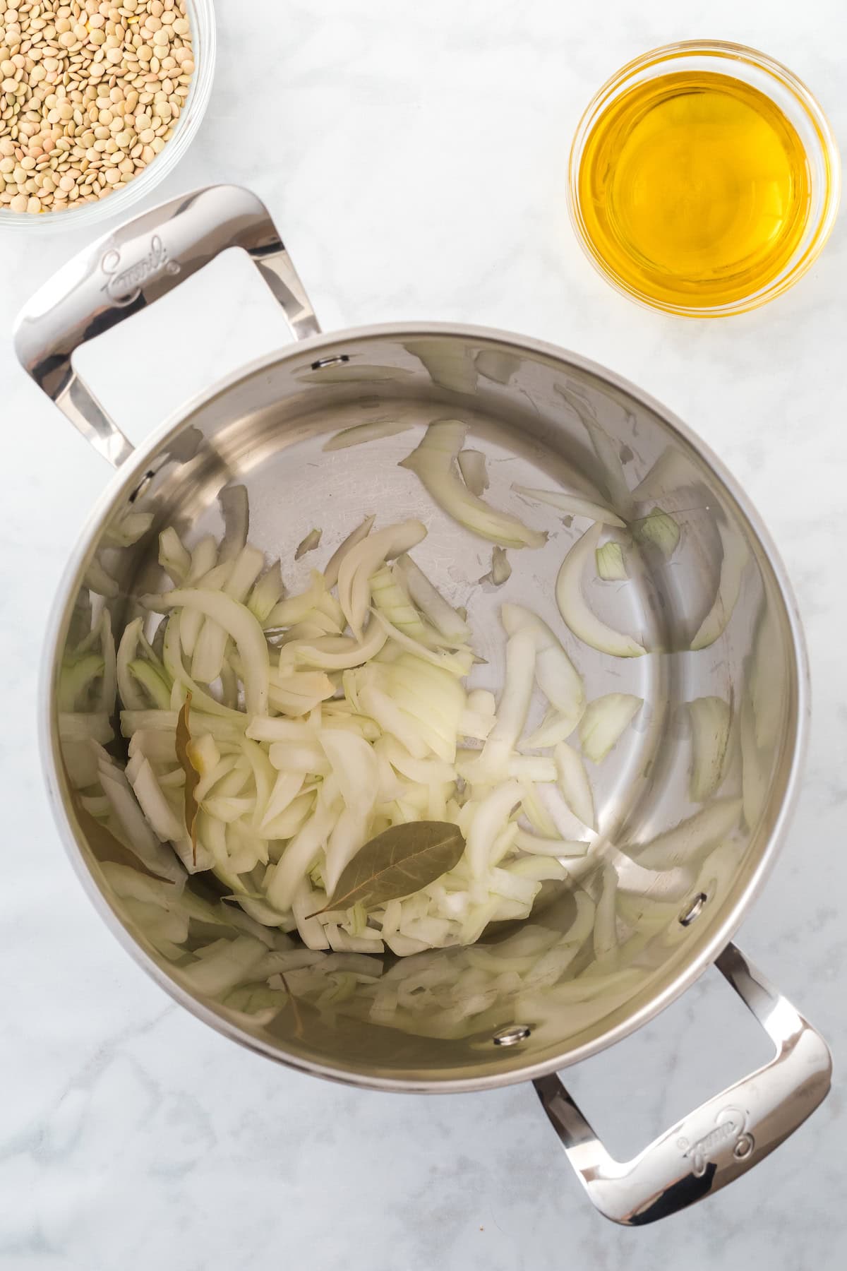 onions and bay leaves in a soup pan.