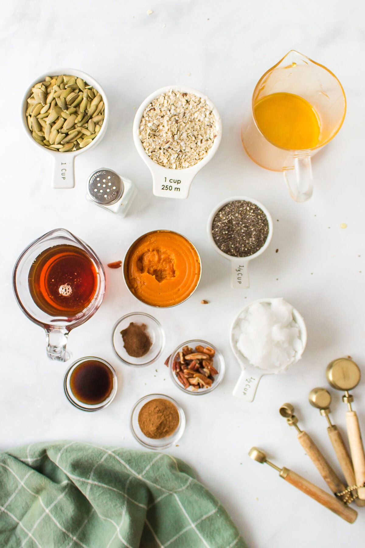 ingredients for the pumpkin granola in small bowls. 