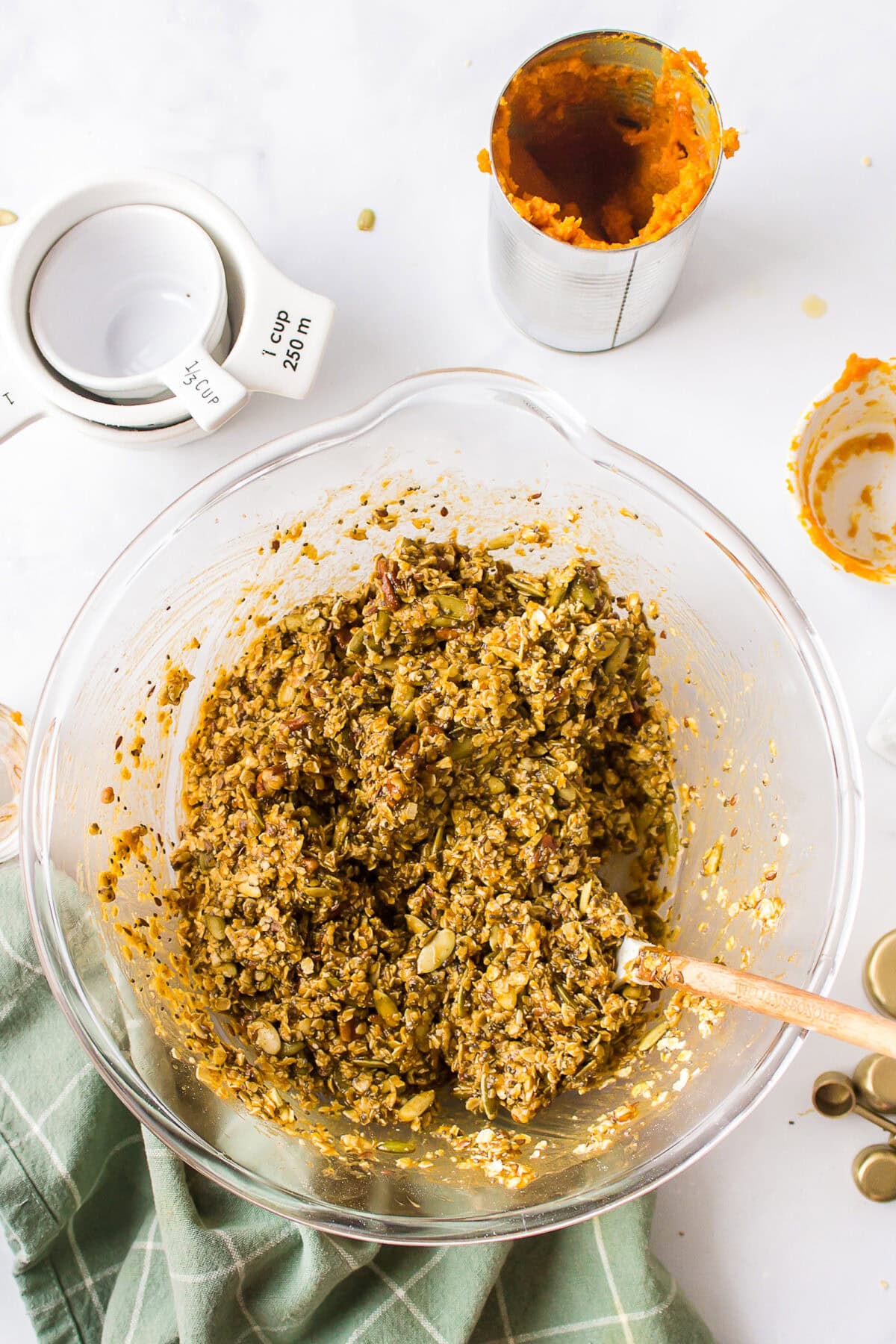 large mixing bowl filled with ingredients combined for the maple pumpkin granola. 