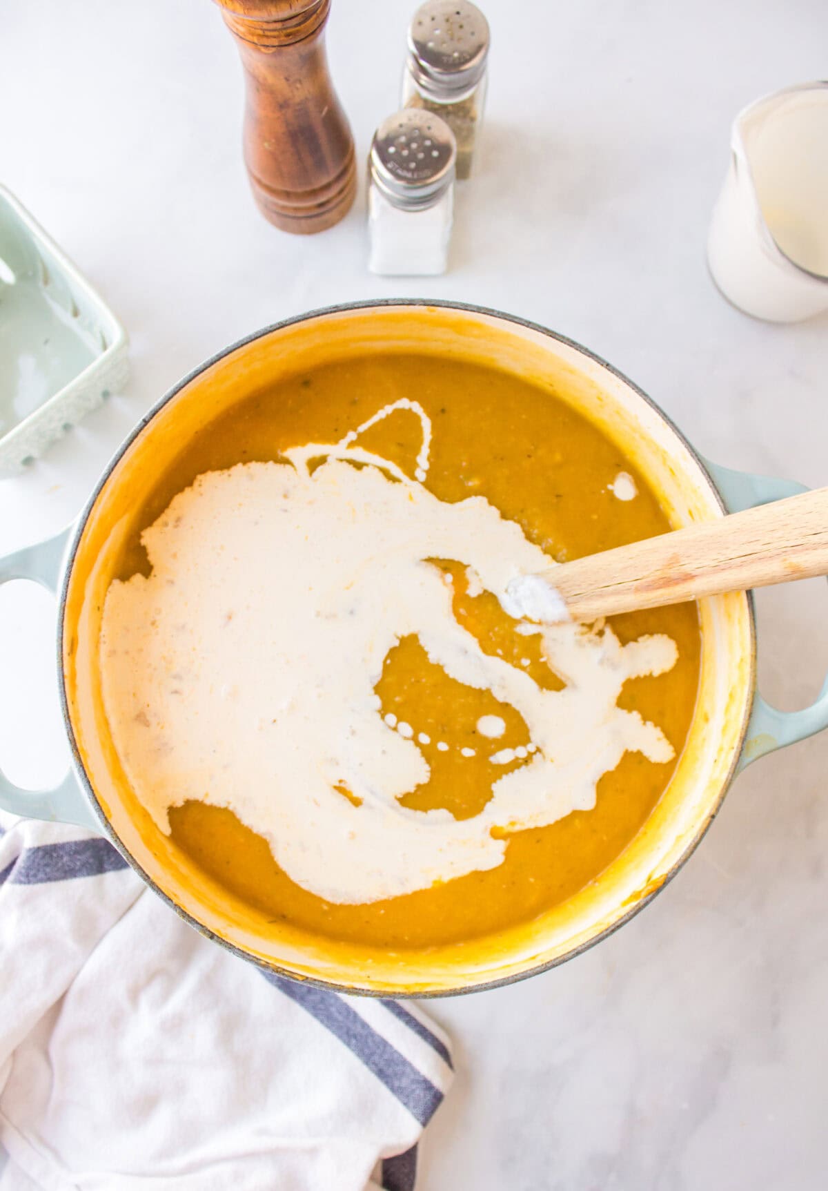 adding the heavy cream to the creamy soup mixture. 