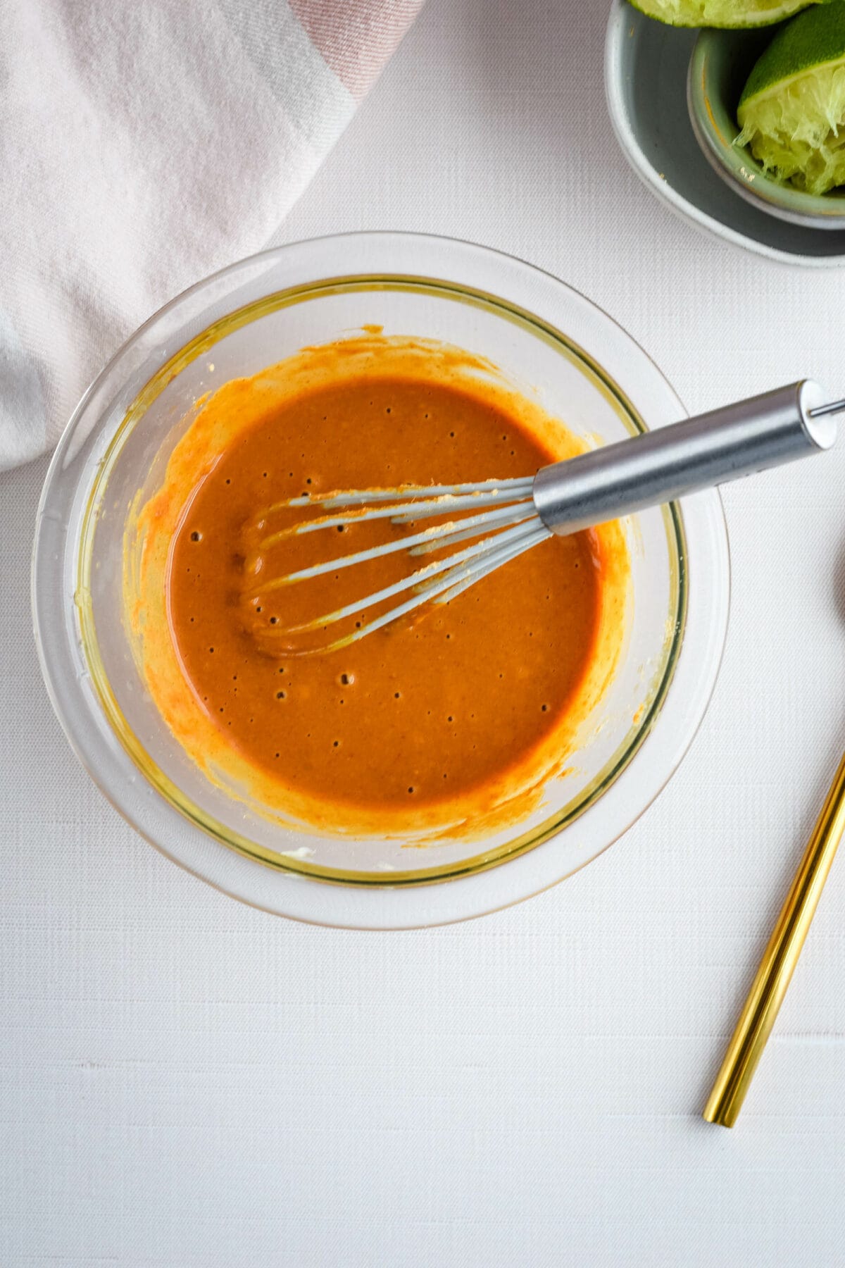 Thai peanut sauce whisked together in a small mixing bowl. 